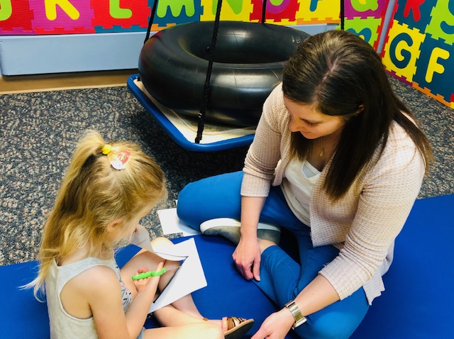 Image of Taylor Physical Therapy's therapist with a peds patient Physical Therapist Kristen Kahler