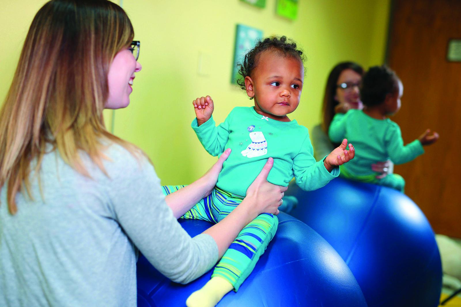 Image of Taylor Physical Therapy's therapist with a peds patient Physical Therapist Kristen Kahler
